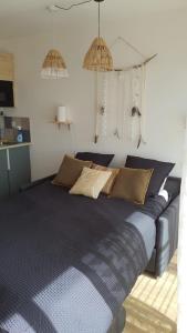 a bedroom with a blue bed with pillows on it at Joli Studio cavalaire in Cavalaire-sur-Mer