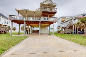a large house with a deck on a sidewalk at Sea Breeze in Galveston