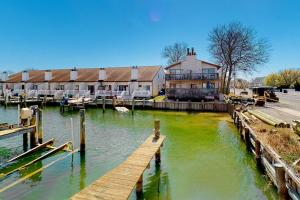a dock in front of a house on a river at The Coral Starfish #10J in Ocean City