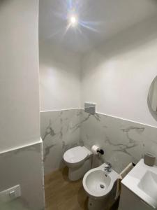 a white bathroom with a toilet and a sink at Marea in Palermo +14 photos