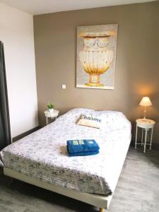 a bedroom with a large bed with a white comforter at Le Relais Bastide de Cordes sur Ciel in Cordes-sur-Ciel