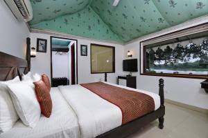 een slaapkamer met een bed met een groen plafond bij Shree Vilas Orchid By Lake Pichhola in Udaipur