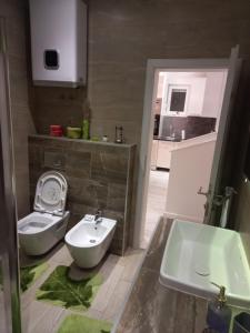 a bathroom with a toilet and a sink at Lux Old Bridge in Mostar