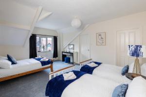 a bedroom with two beds and a window at Wharfedale Retreat in Ilkley