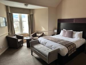 A bed or beds in a room at The Acarsaid - Pitlochry