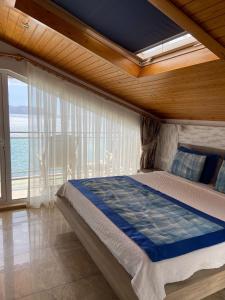 a bedroom with a bed with a view of the ocean at Narr Hotel in Kaş