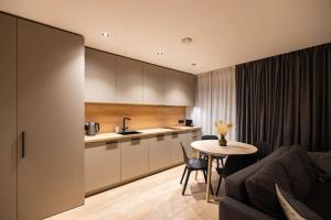 a kitchen and a living room with a table at Apartment in Cēsis in Cēsis