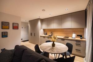 a living room with a table and a kitchen at Apartment in Cēsis in Cēsis