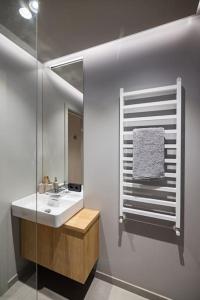 a bathroom with a sink and a mirror at Apartment in Cēsis in Cēsis