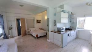 a room with a kitchen and a living room at Hotel Mato in Skiathos Town