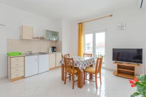 a kitchen and dining room with a table and chairs at Apartments Anastazija in Vodice