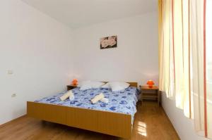 Postel nebo postele na pokoji v ubytování Apartments Anastazija