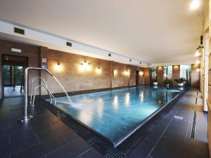 a swimming pool in a building with a pool at VacationClub - Cristal Resort Apartament 314 in Szklarska Poręba
