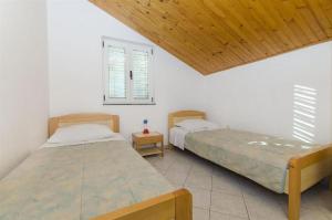 Postel nebo postele na pokoji v ubytování Apartments Nada