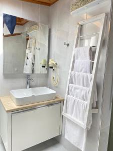 a bathroom with a sink and a mirror and towels at Narr Hotel in Kaş