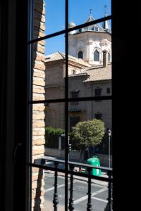a view of a building from a window at Hotel Boutique Las Almenas in Granada