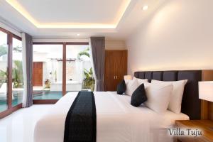 a bedroom with a large bed and a pool at Villa Mia Seminyak - Boutique Villas in Seminyak +31 photos