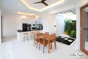 a kitchen and dining room with a wooden table and chairs at Villa Mia Seminyak - Boutique Villas in Seminyak