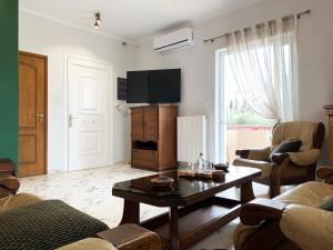 a living room with a couch and a table at Vintage Manor in Anavyssos