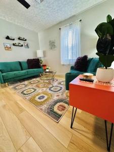 a living room with a green couch and a rug at Black Ridgetop at NRG National Park in Lansing