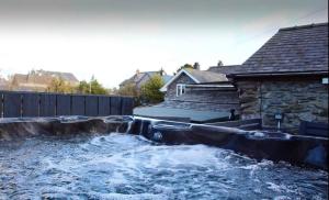 a water fall in the backyard of a house at Brackendale in Bala