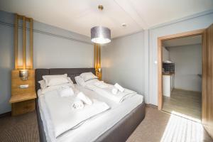 Postel nebo postele na pokoji v ubytování Park Hotel Ambrózia