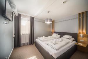 Postel nebo postele na pokoji v ubytování Park Hotel Ambrózia + 29 fotografií