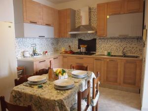 a kitchen with a table with plates on it at Casa Skyline a Ravello in Atrani