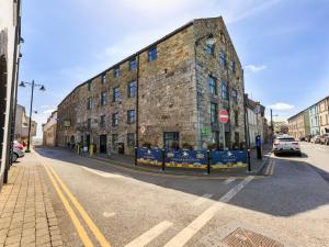 a large brick building on the side of a street at Crew's Apartment in Dungarvan