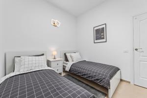 two beds sitting next to each other in a bedroom at Home2Book Charming Apartment Teguise, Terrace in Teguise