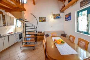 a kitchen and a table with a bowl of fruit on it at House Kastel in Tkon +31 photos