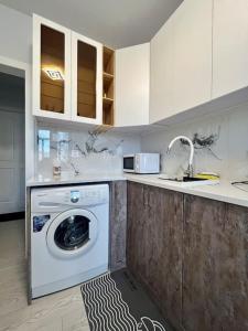 a kitchen with a washing machine and a sink at Newly renovated rental unit with free parking in Ulaanbaatar