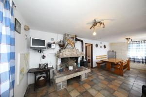 a living room with a stone fireplace and a table at House Lovre in Tkon