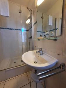 a bathroom with a sink and a shower at Landhaus Bode in Travemünde +108 photos