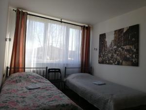 um quarto com 2 camas individuais e uma janela em Bridge Apartments Klaipeda em Klaipėda