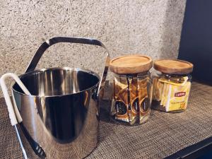 a bucket and two jars of honey on a table at TABISAI HOTEL Grande 博多 in Fukuoka