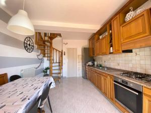 a kitchen with wooden cabinets and a dining table at Sunrise apartament in Monterosso al Mare