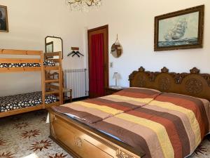 a bedroom with a bed and a bunk bed at La Margherita di Teriasca in Teriasca