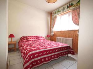 Un dormitorio con una cama con una manta roja. en Comfortable Holiday Home in Chatel with Roof Terrace, en Châtel
