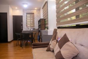 a living room with a couch and a table at Casa Amanda bungalow with hi-speed internet in Coron