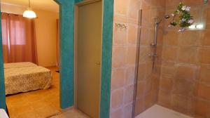 a bathroom with a shower with a glass door at VILLA 4pers, STUNNING SEA VIEW, BEACH ON FOOT 4* in Olmeto