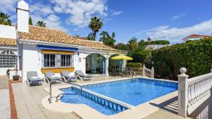 a swimming pool in the backyard of a house at Villa Caleta Ref 196 in Fuengirola