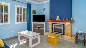 a living room with a fireplace and a tv at Villa Caleta Ref 196 in Fuengirola