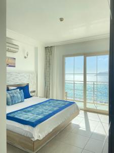 a bedroom with a bed and a view of the ocean at Narr Hotel in Kaş