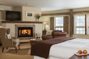 a hotel room with a bed and a fireplace at Glasbern in Fogelsville