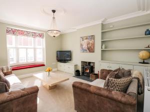 a living room with two couches and a tv at The Eastgate Apartment in Louth