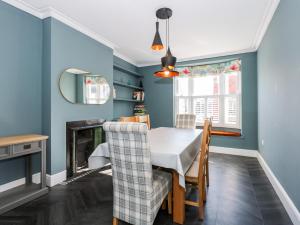a dining room with a table and chairs and a fireplace at The Eastgate Apartment in Louth