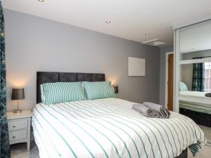 a bedroom with a large bed and a window at The Eastgate Apartment in Louth