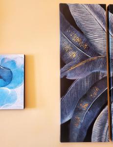 a painting of a feather hanging on a wall at Residenza FillAnfi in Lucca