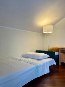 a bedroom with a bed and a lamp in it at Attico Chiavari in Chiavari